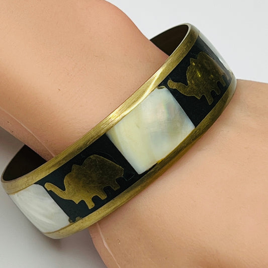 Brass elephant bangle worn on wrist, showcasing size and shine