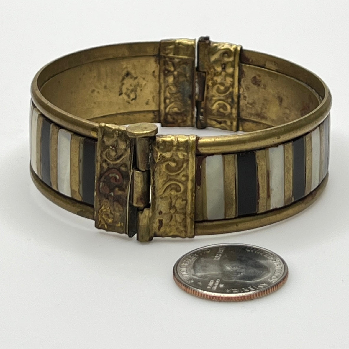 Vintage bangle with pin closure and etched end caps, close-up view