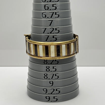 Vintage bangle with pin closure and etched end caps, close-up view