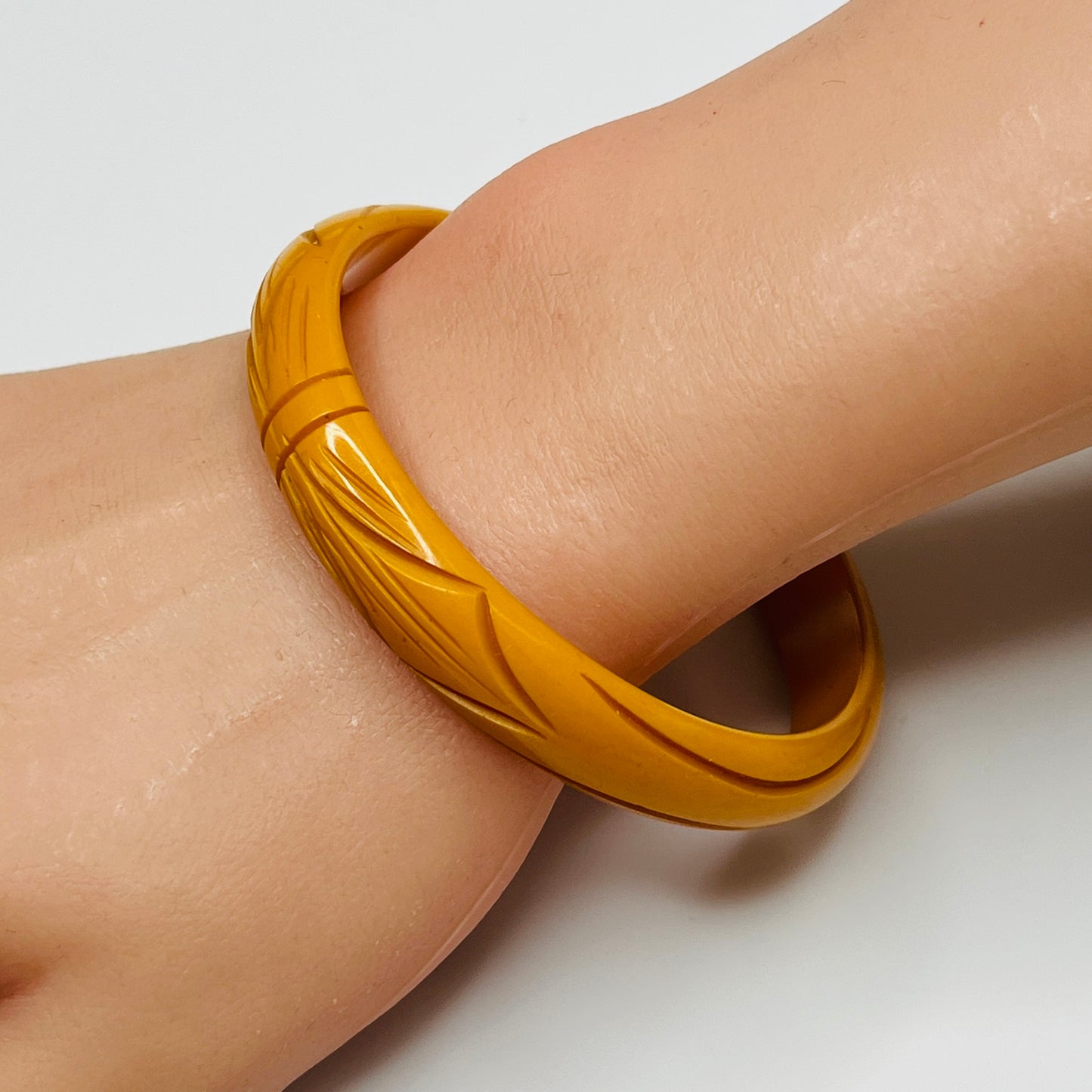 Vintage butterscotch Bakelite bangle with carved leaf design