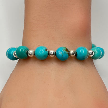 Turquoise and silver beaded bracelet worn on wrist – 9mm stones