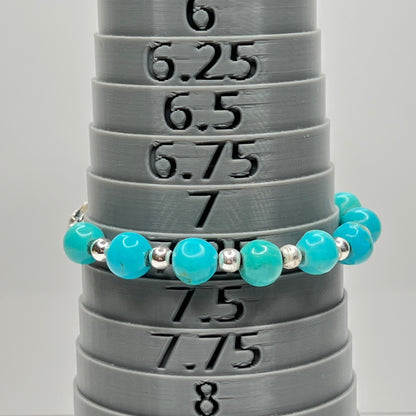 Turquoise and silver beaded bracelet on bracelet mandrel