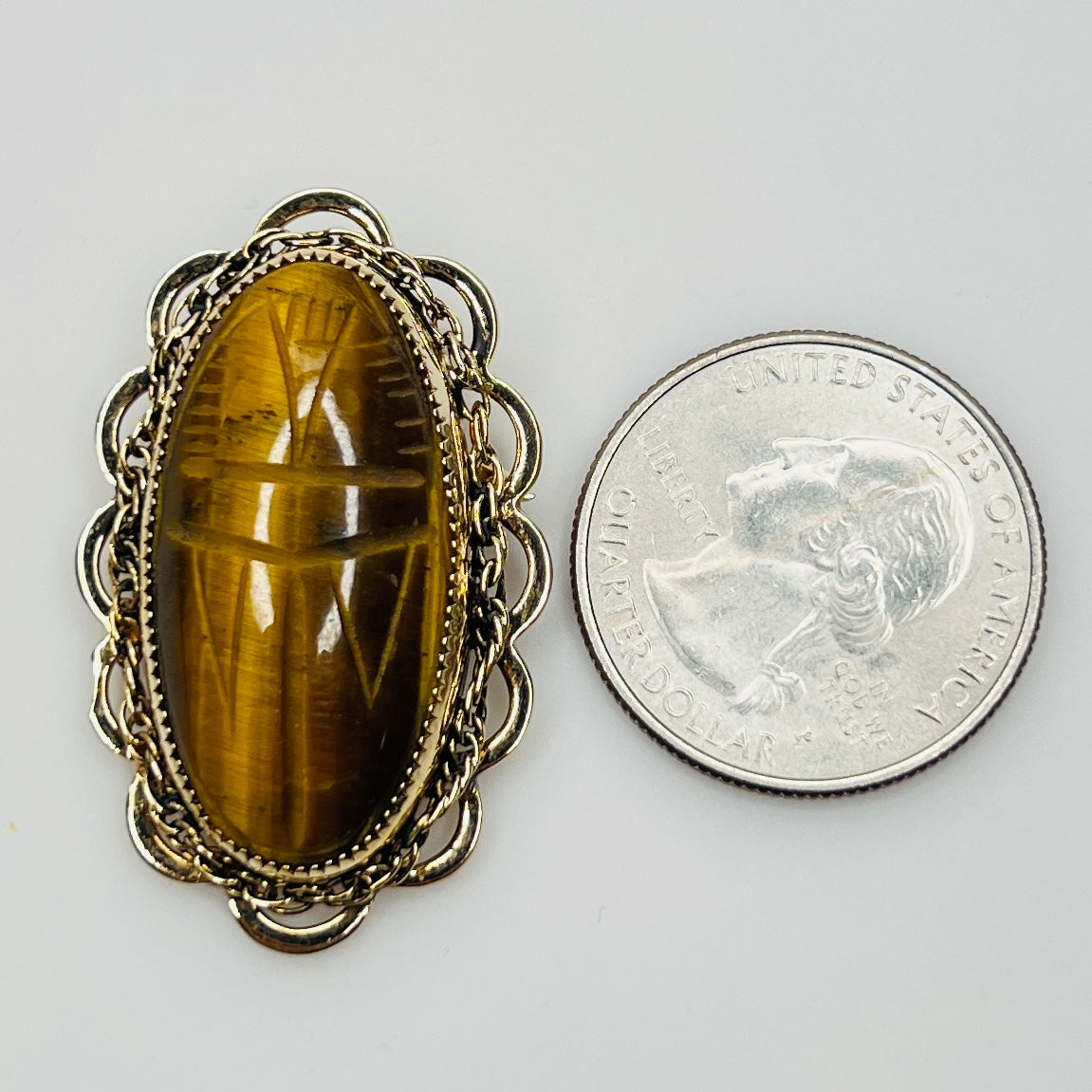 Vintage Catamore brooch with carved tiger’s eye scarab and gold-filled filigree frame