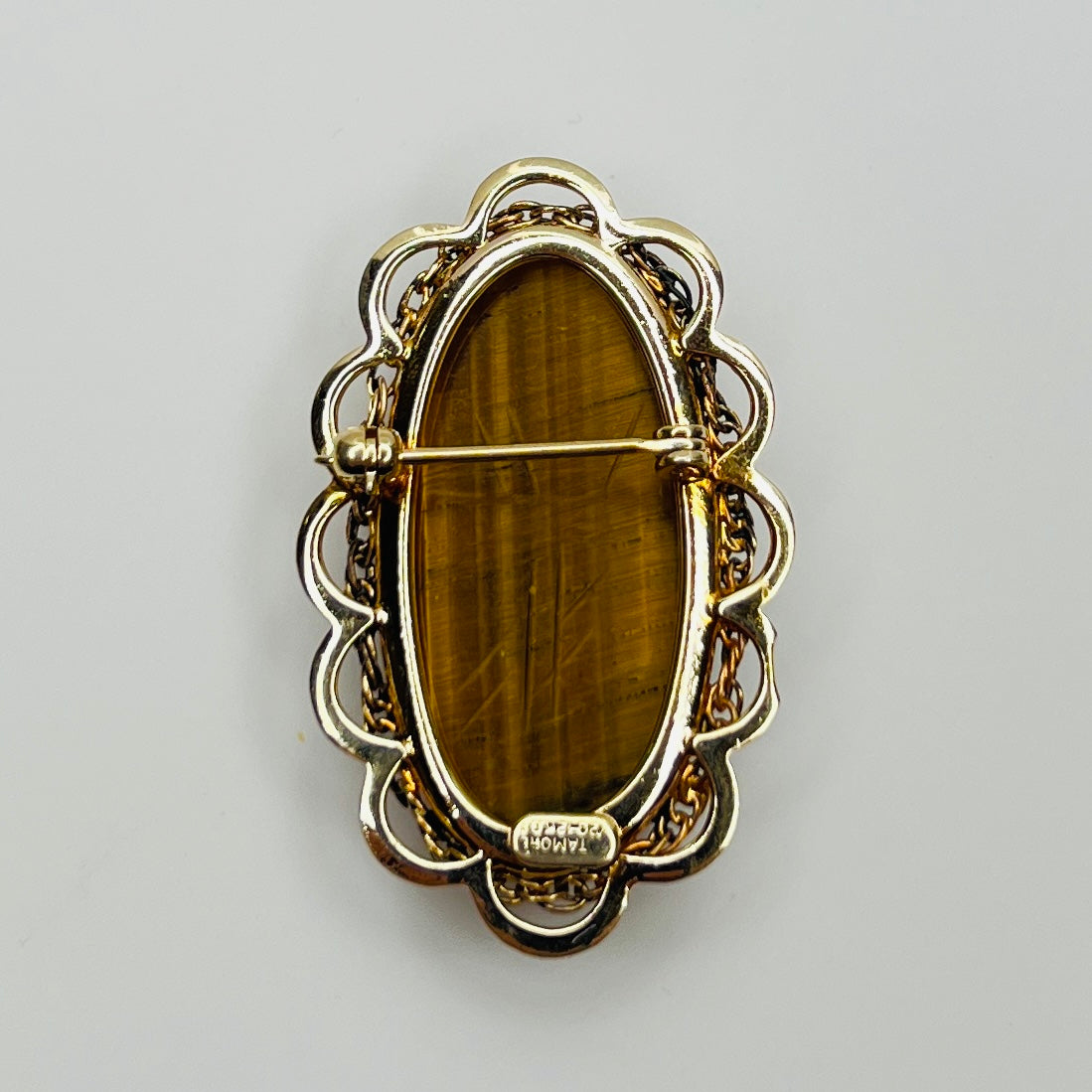Reverse showing Catamore 12K gold-filled mark and pin mechanism