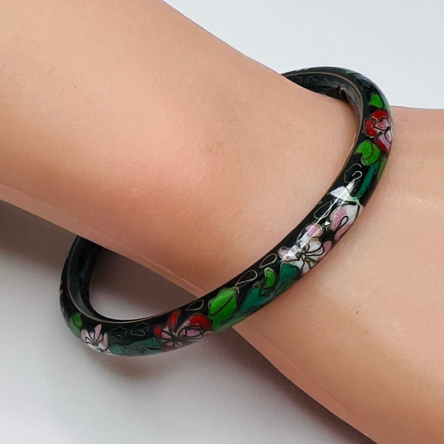 Side view of enamel floral bracelet on wrist