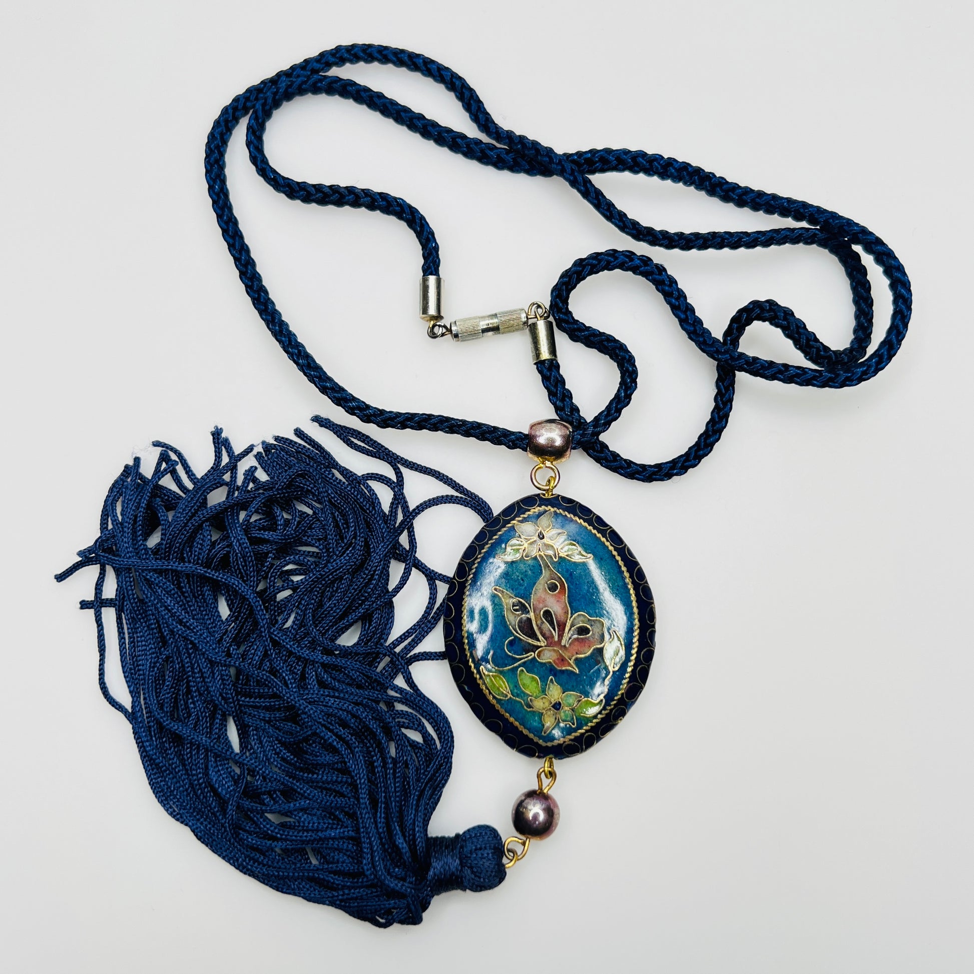 Close-up of butterfly cloisonné pendant with tassel drop