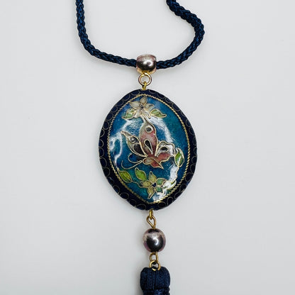 Close-up of butterfly cloisonné pendant with tassel drop