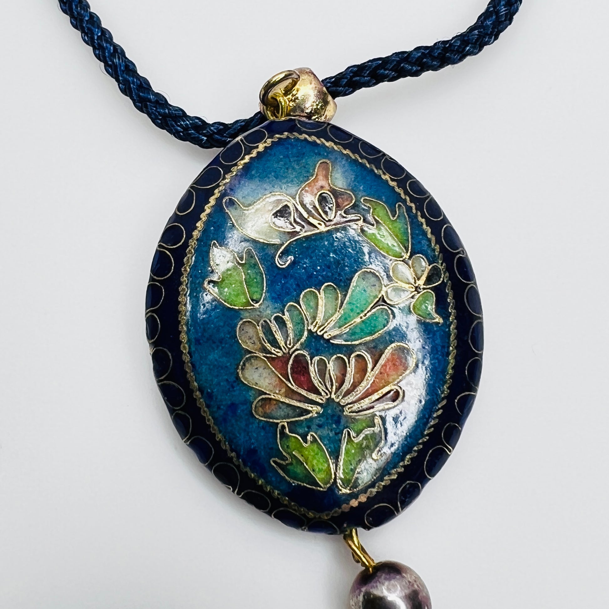 Detail of floral cloisonné side of reversible pendant
