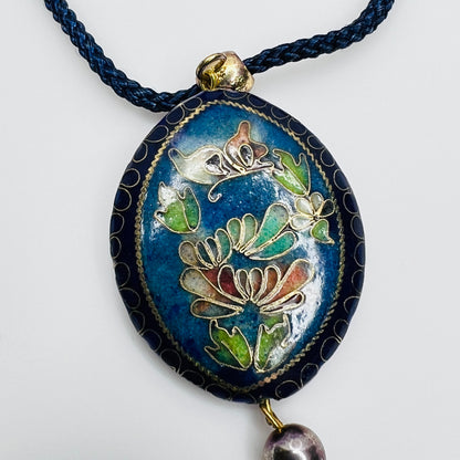 Detail of floral cloisonné side of reversible pendant
