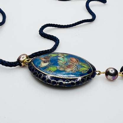 Close-up of butterfly cloisonné pendant with tassel drop
