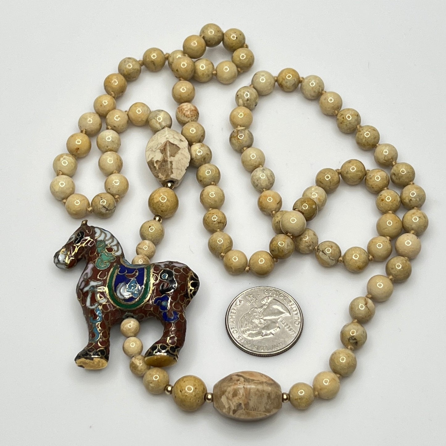 Detail of cloisonné horse pendant with multicolor enamel work