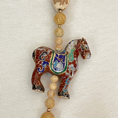 Detail of cloisonné horse pendant with multicolor enamel work
