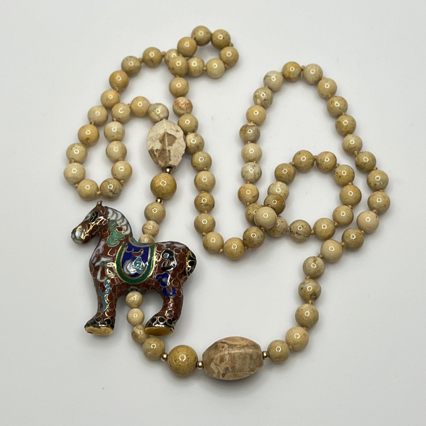 Hand-knotted beige stone bead strand with asymmetrical design