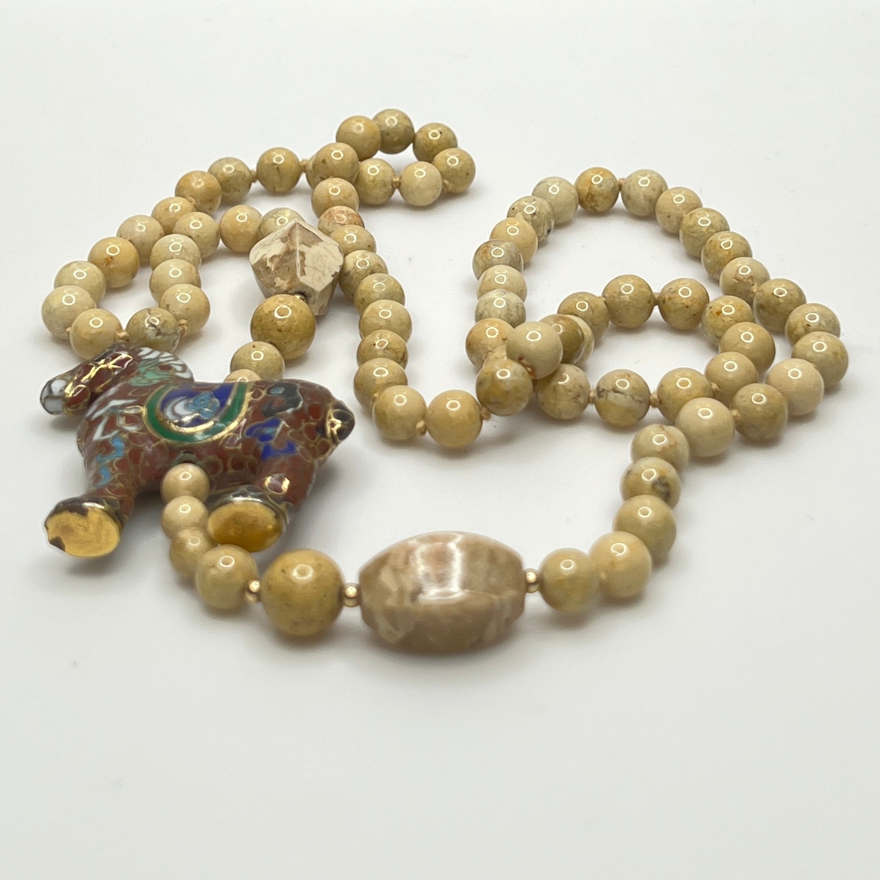 Hand-knotted beige stone bead strand with asymmetrical design