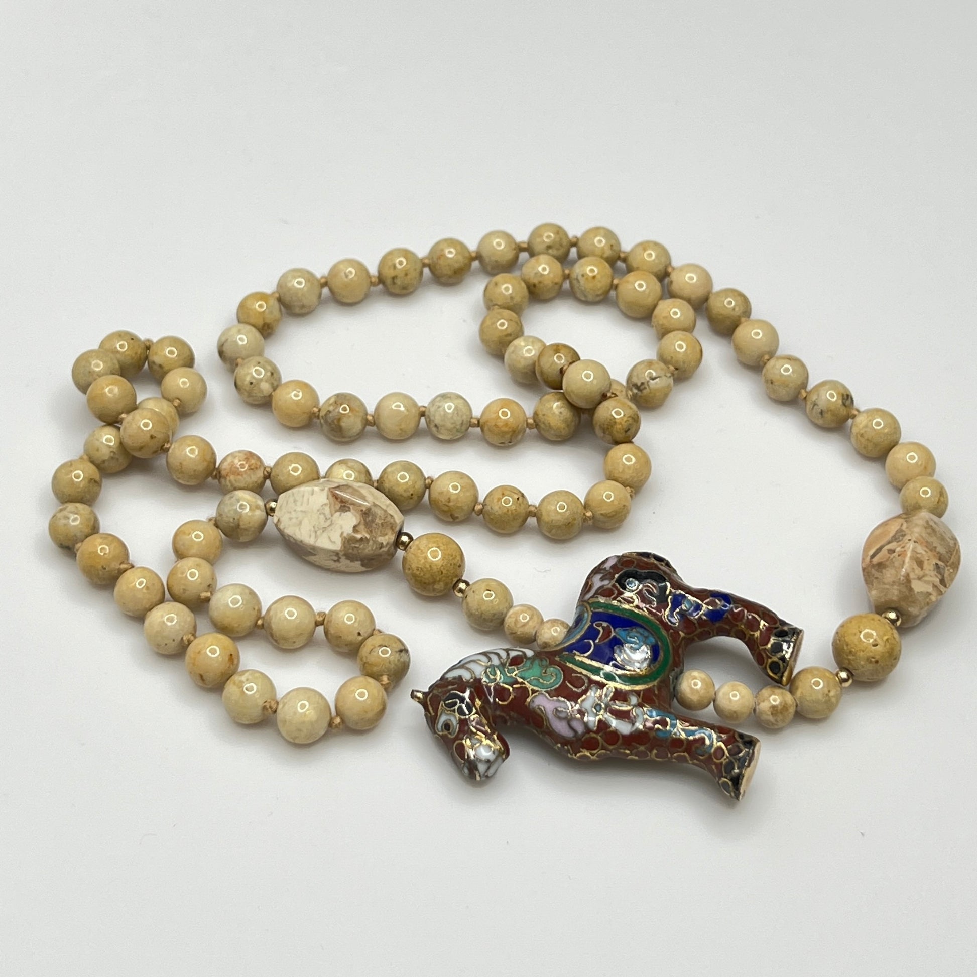 Hand-knotted beige stone bead strand with asymmetrical design
