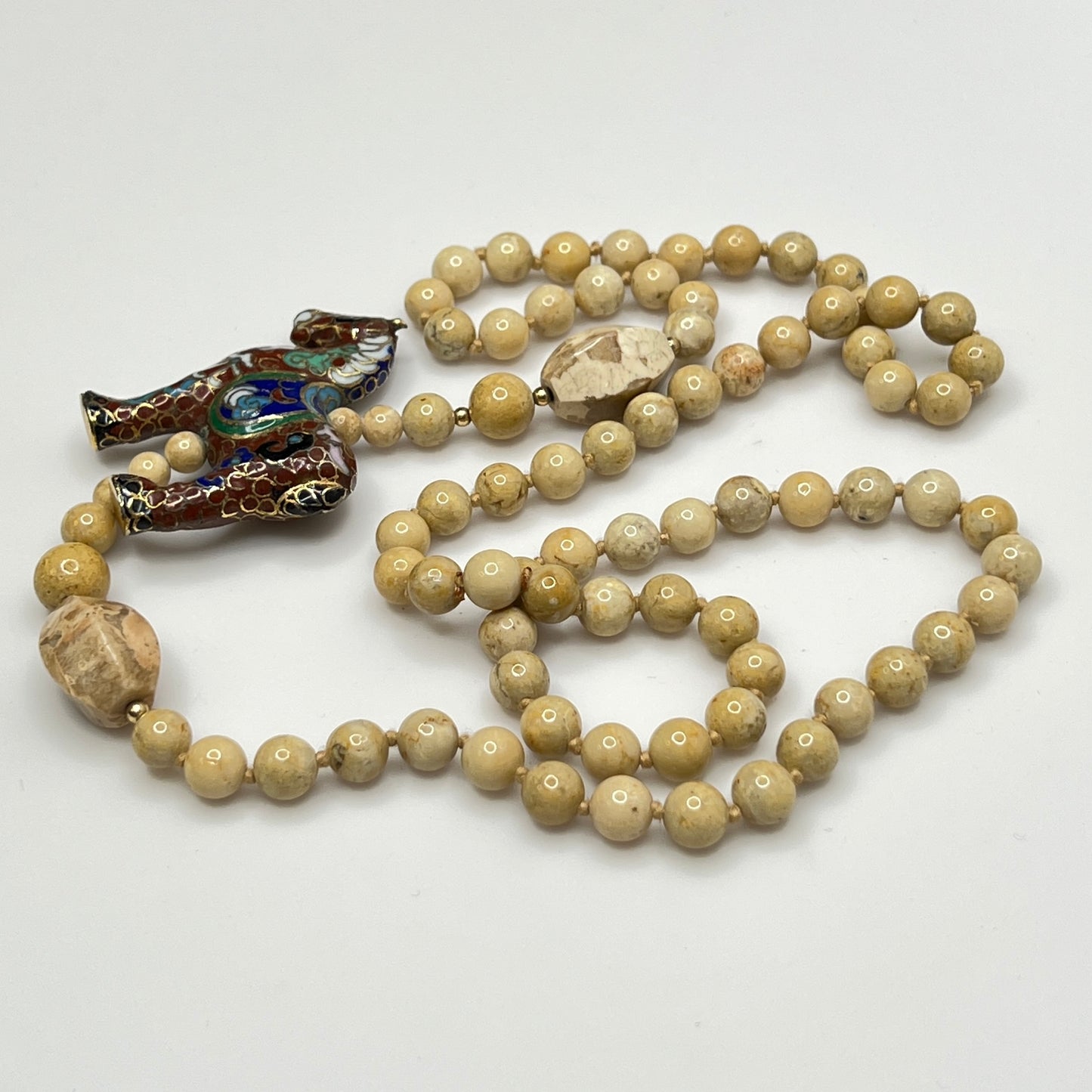 Hand-knotted beige stone bead strand with asymmetrical design