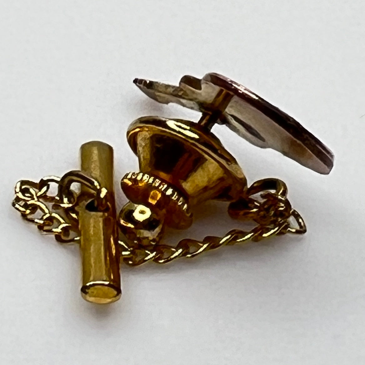 1960s copper guitar tie tack with gold tone chain and detailed fretwork