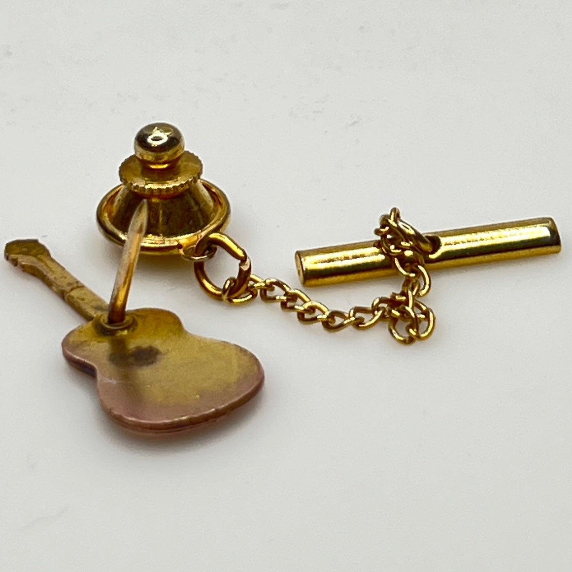 Back view showing tack clutch and gold tone safety chain