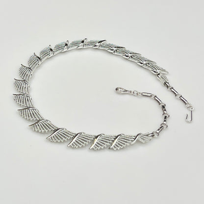 Side view of textured and polished mid-century fan design