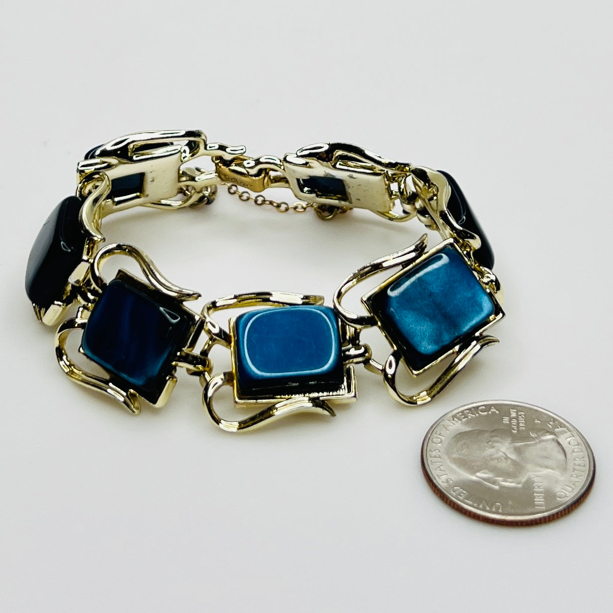 Vintage Coro bracelet with marbled blue thermoset cabochons, laid flat