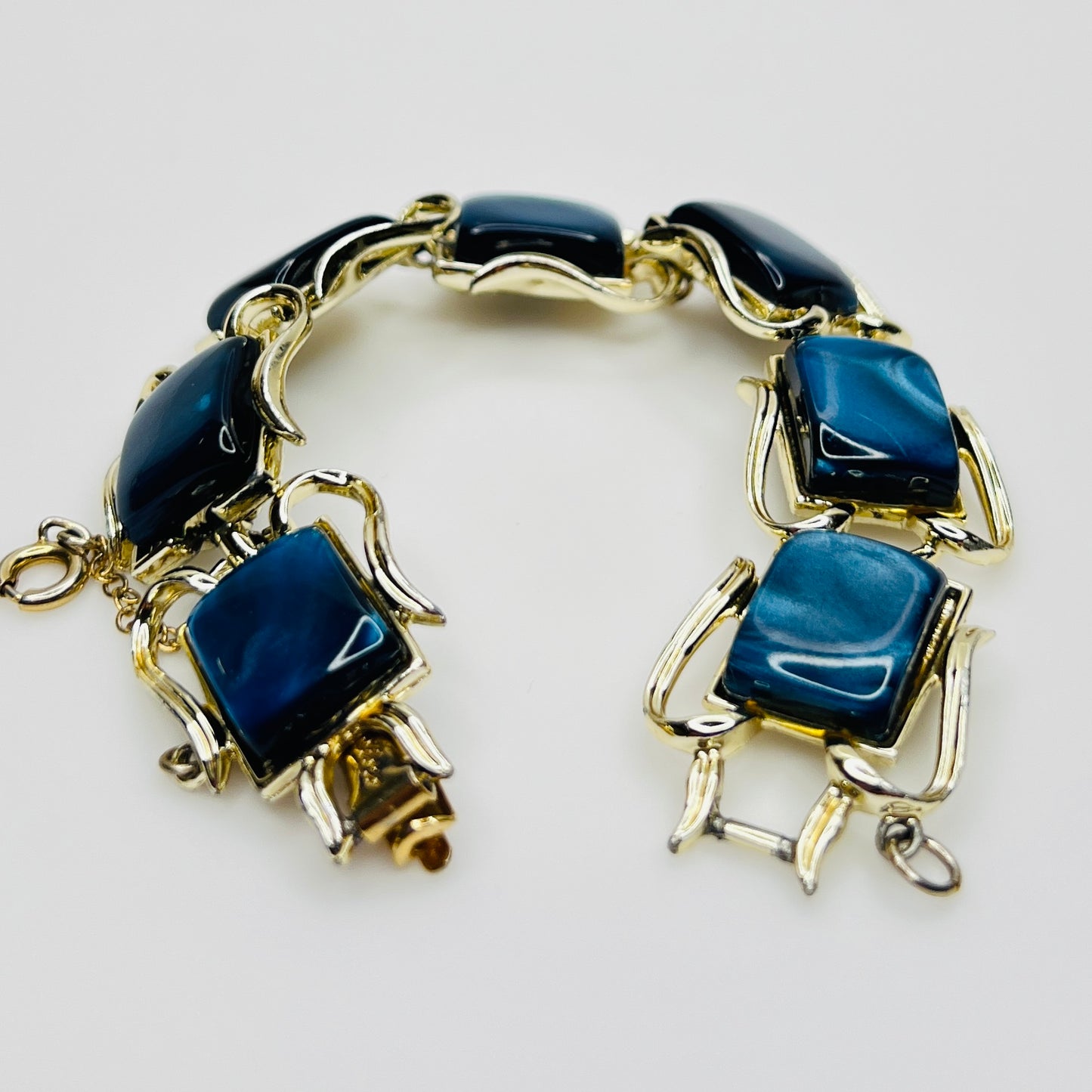 Vintage Coro bracelet with marbled blue thermoset cabochons, laid flat