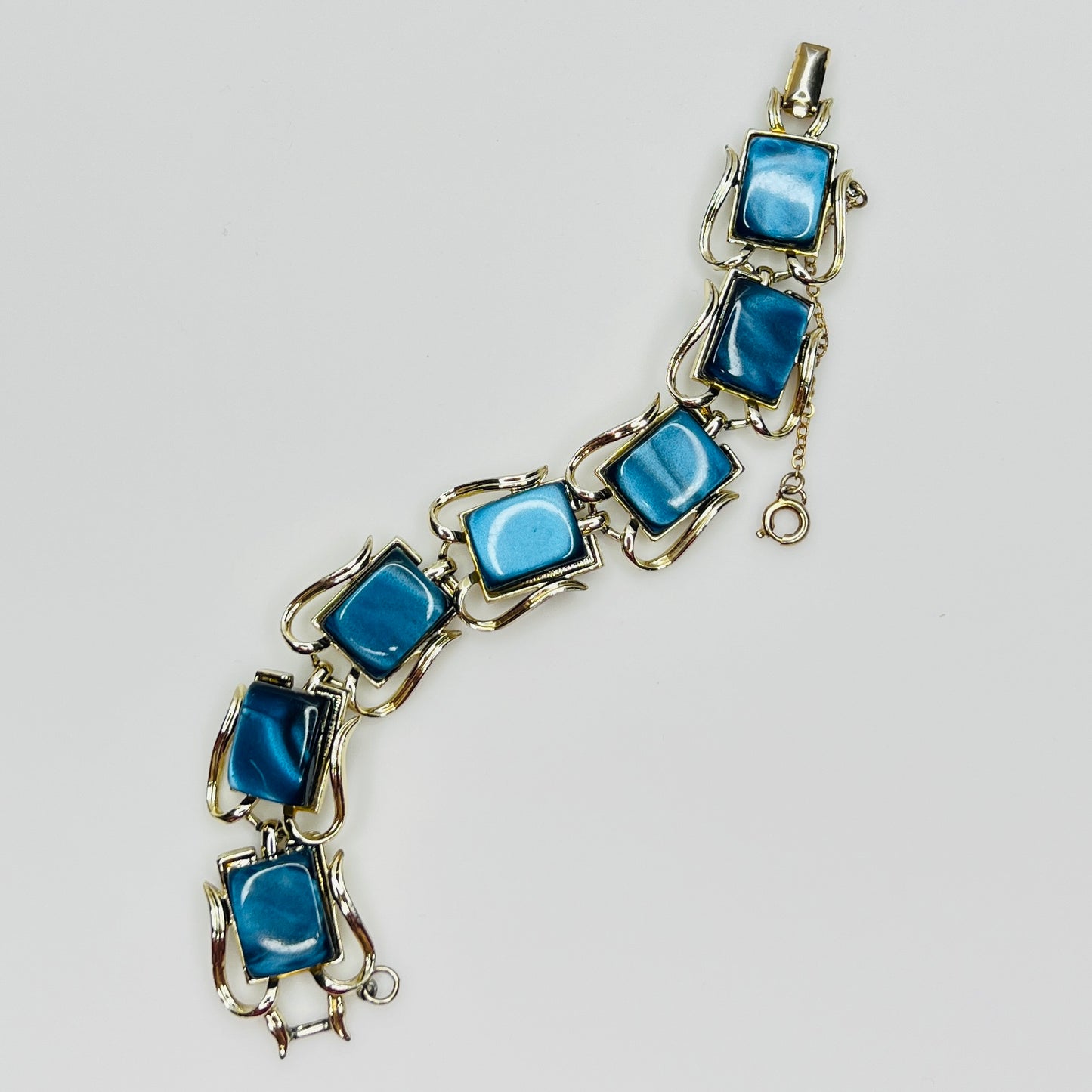 Vintage Coro bracelet with marbled blue thermoset cabochons, laid flat