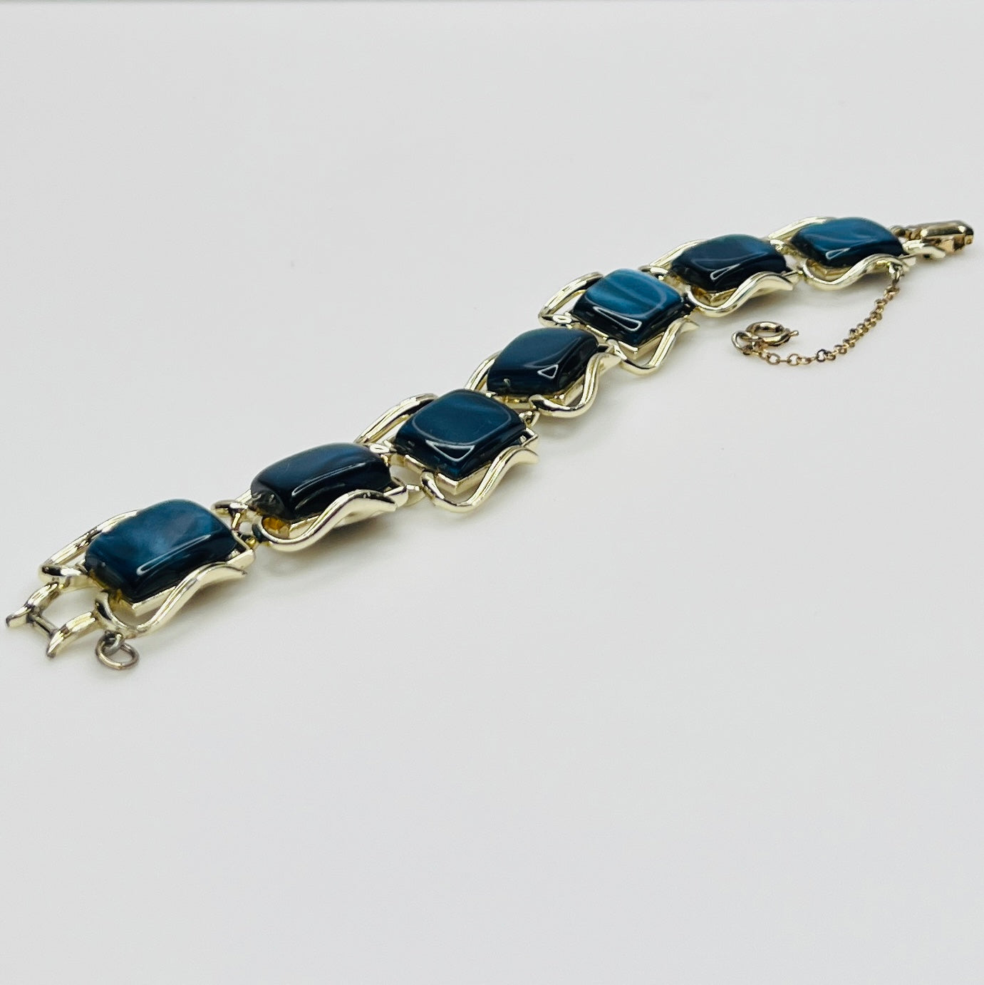 Vintage Coro bracelet with marbled blue thermoset cabochons, laid flat