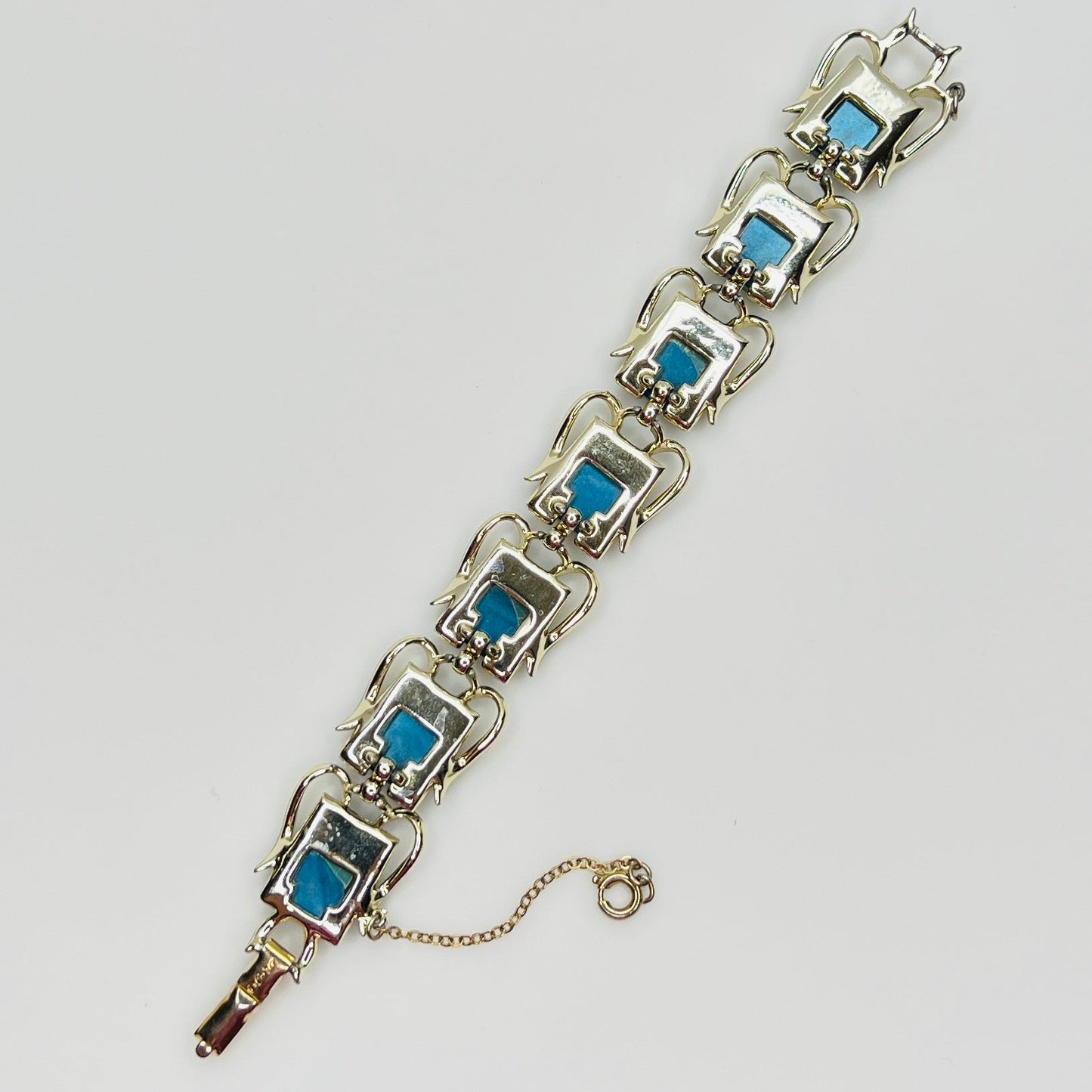 Vintage Coro bracelet with marbled blue thermoset cabochons, laid flat