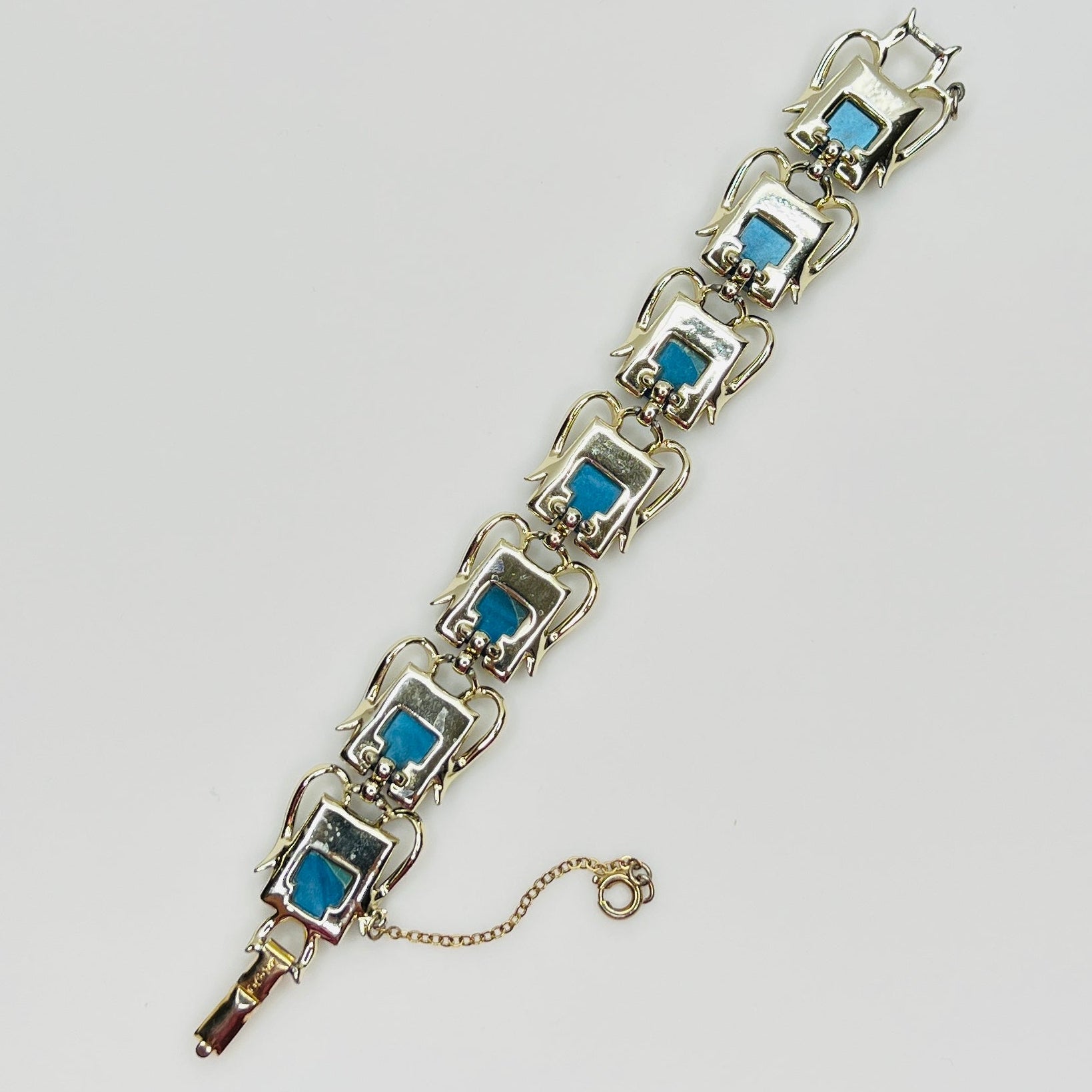 Vintage Coro bracelet with marbled blue thermoset cabochons, laid flat