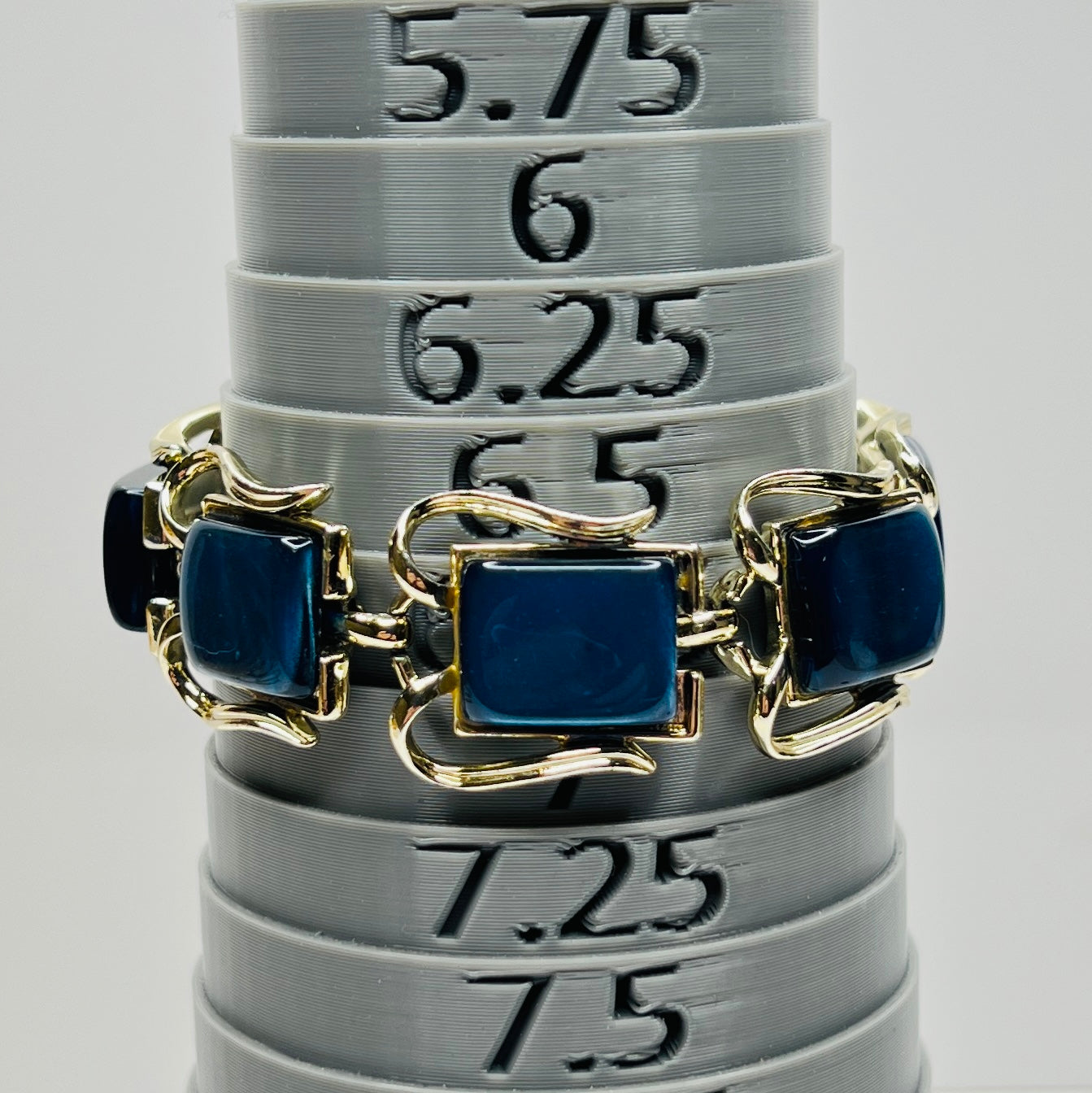 Vintage Coro bracelet with marbled blue thermoset cabochons on bracelet mandrel to show size