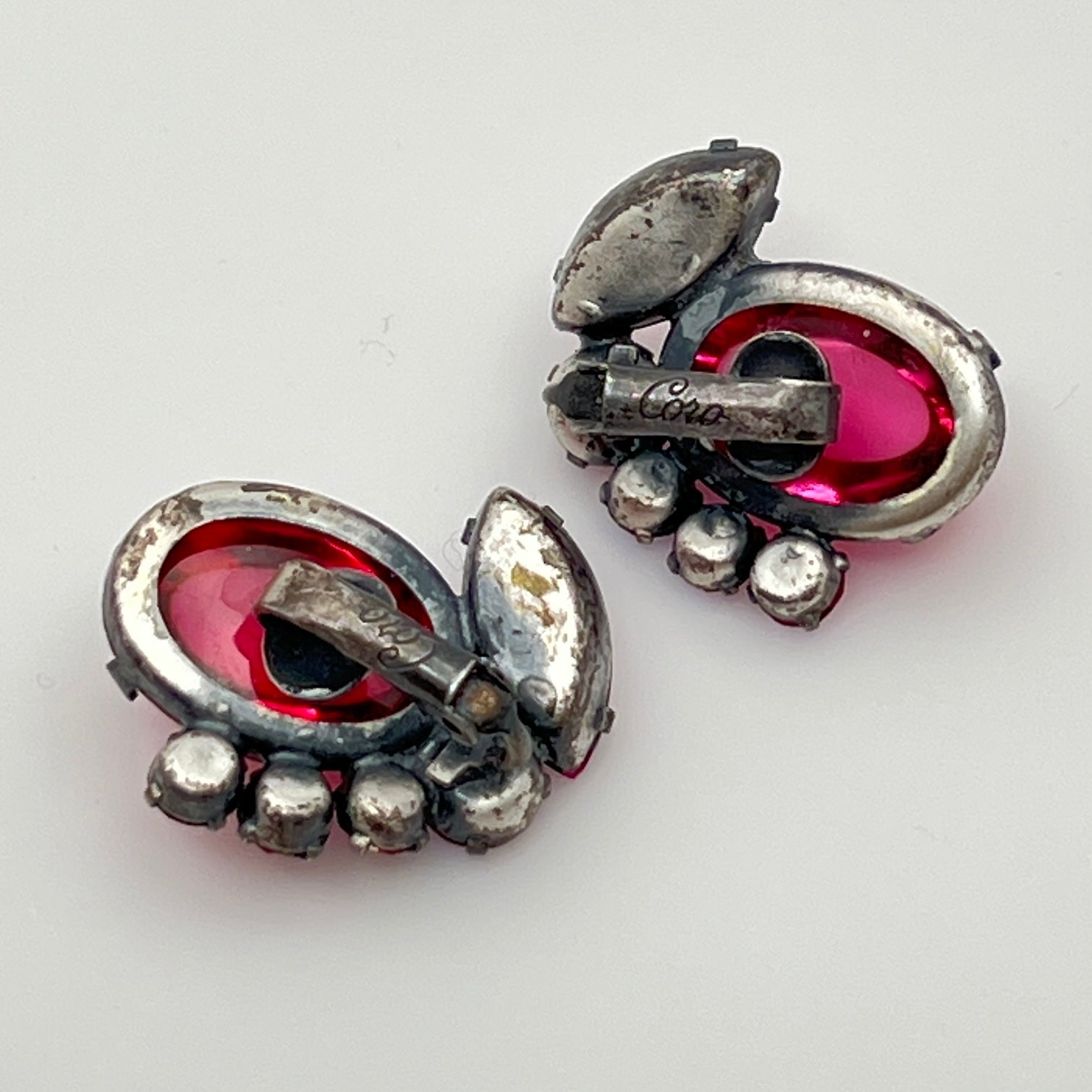 Close-up of signed Coro earrings with prong-set rhinestones