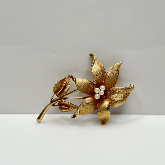 Vintage Coro gold-tone flower brooch with faux pearl center and textured petals