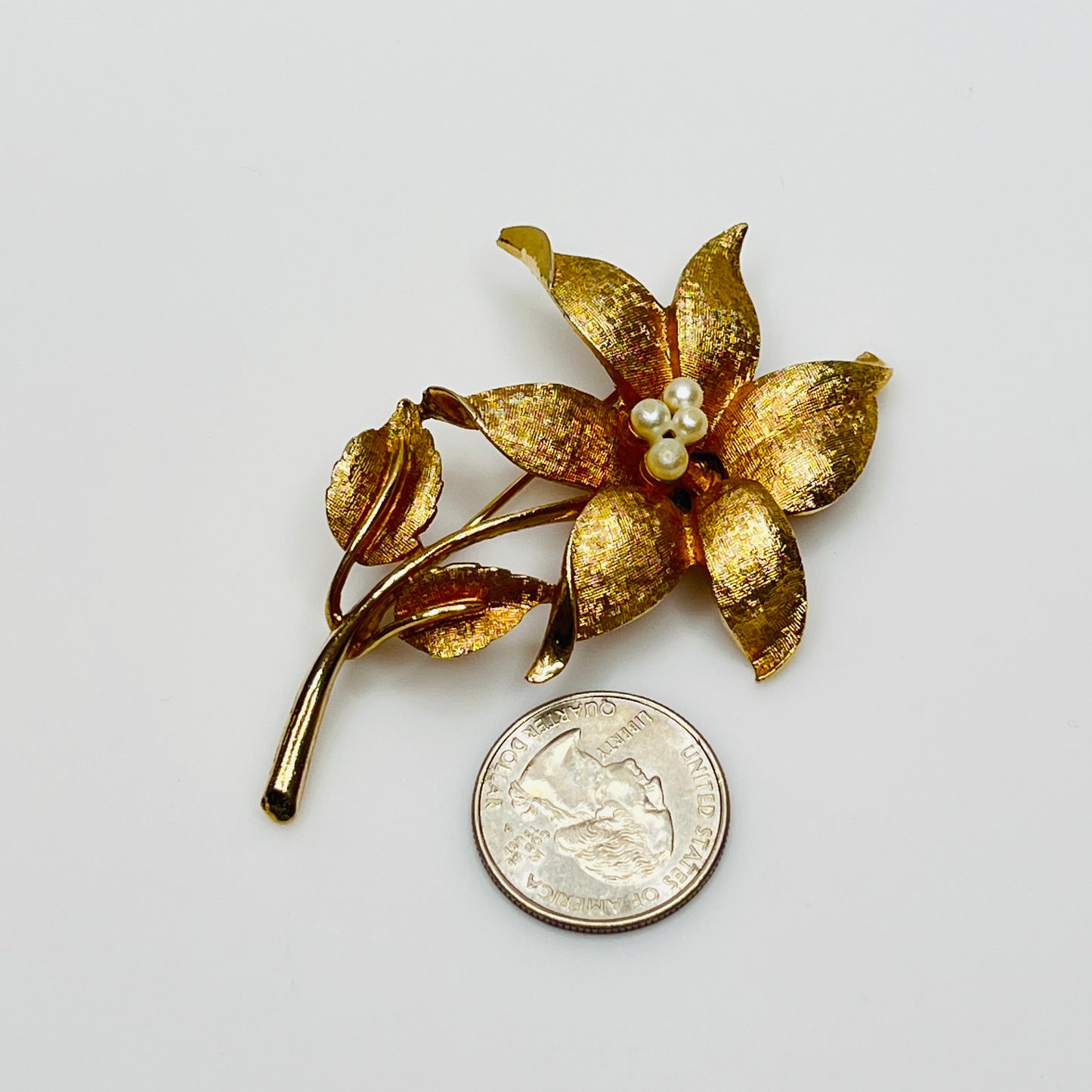 Close-up of signed Coro brooch featuring dimensional flower design