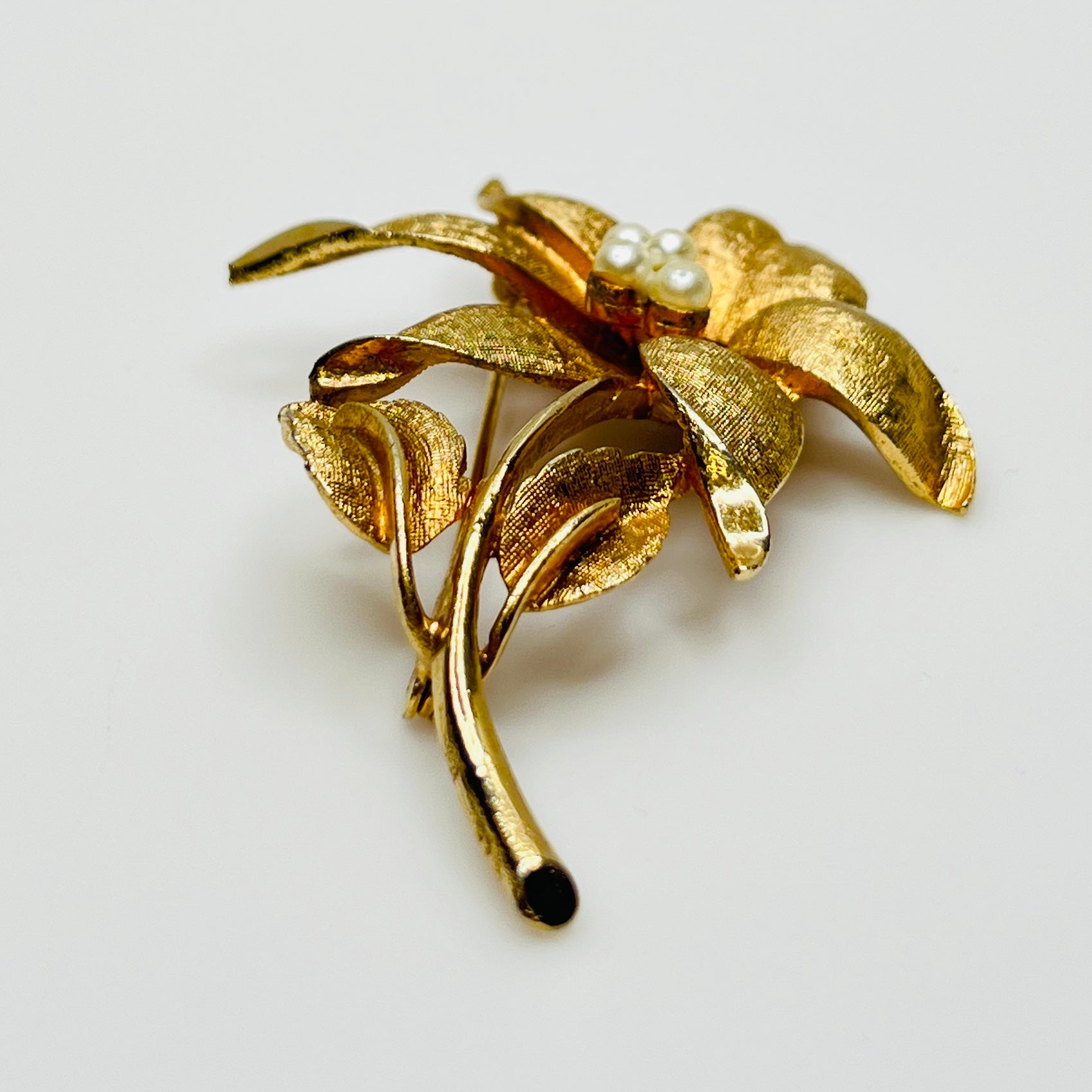 Close-up of signed Coro brooch featuring dimensional flower design
