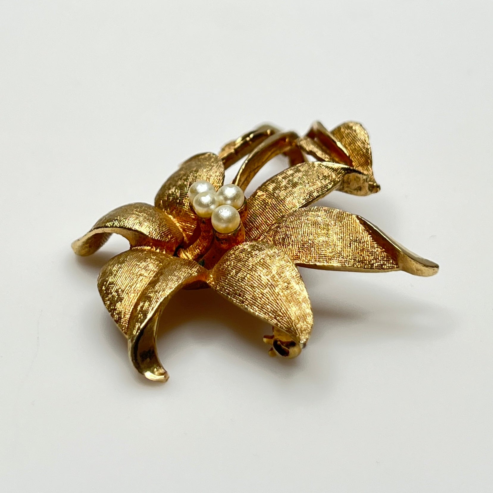 Close-up of signed Coro brooch featuring dimensional flower design