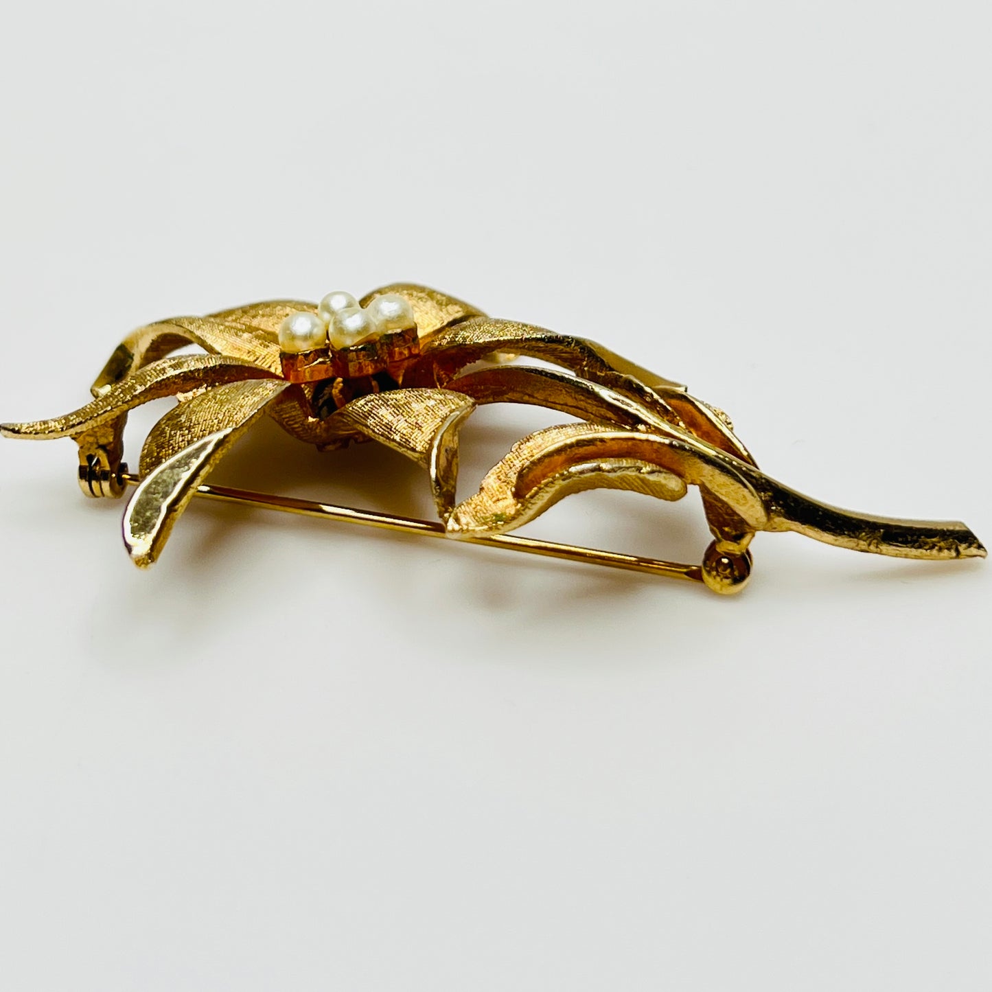 Close-up of signed Coro brooch featuring dimensional flower design