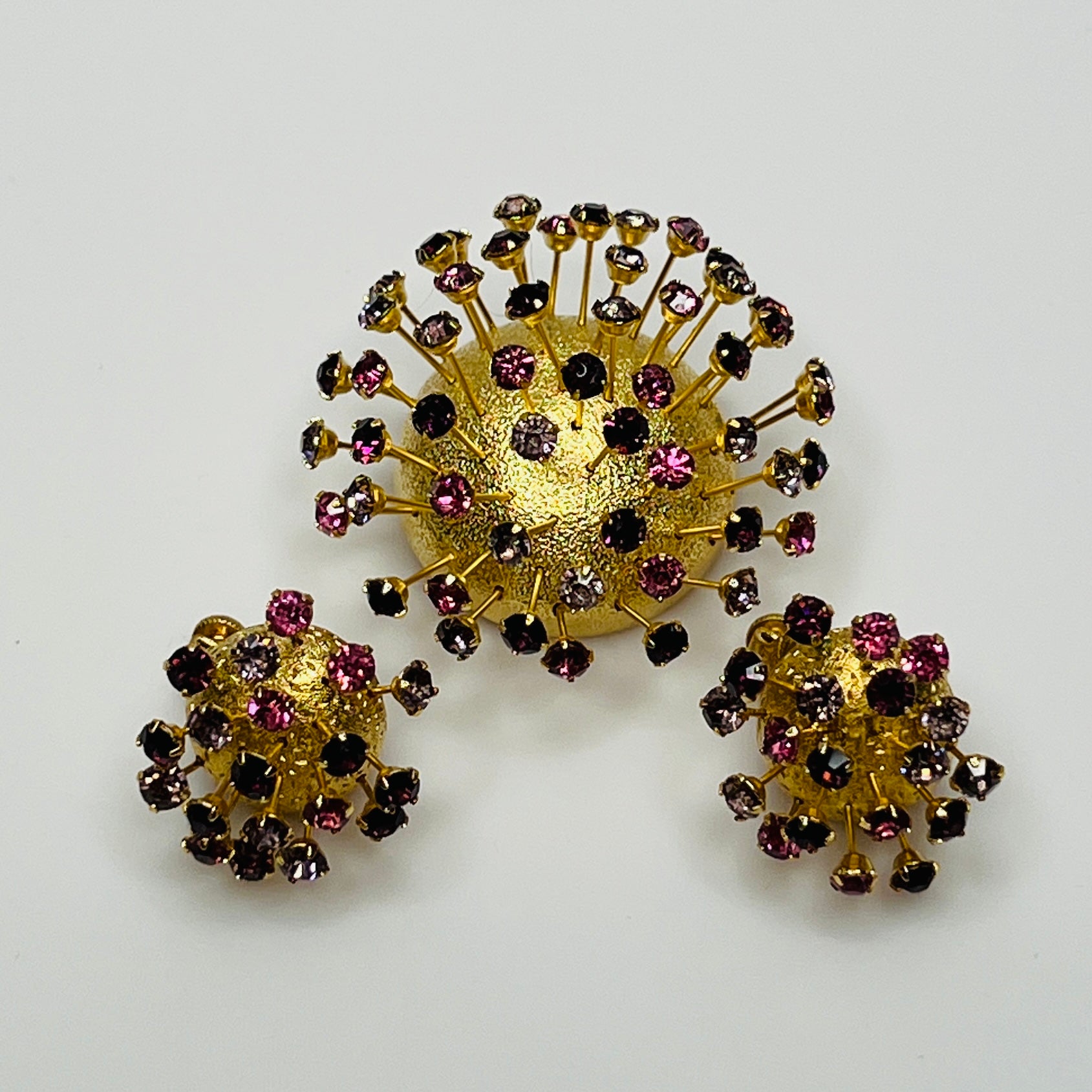 Corocraft goldtone Sputnik brooch with pink and purple rhinestones, mid-century style