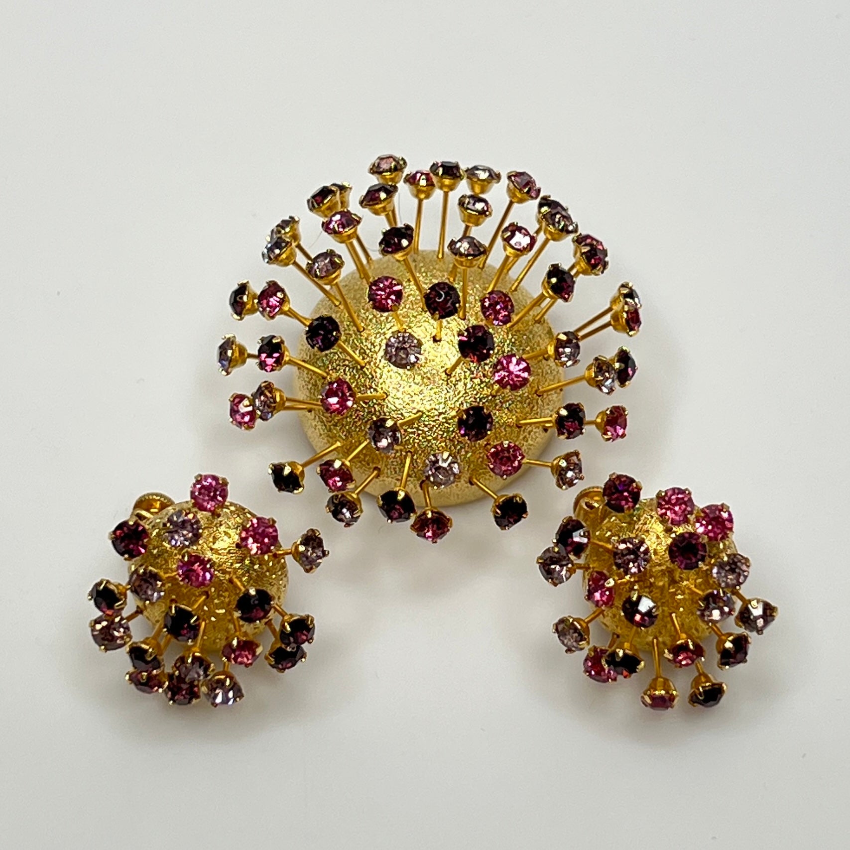 Corocraft goldtone Sputnik brooch with pink and purple rhinestones, mid-century style