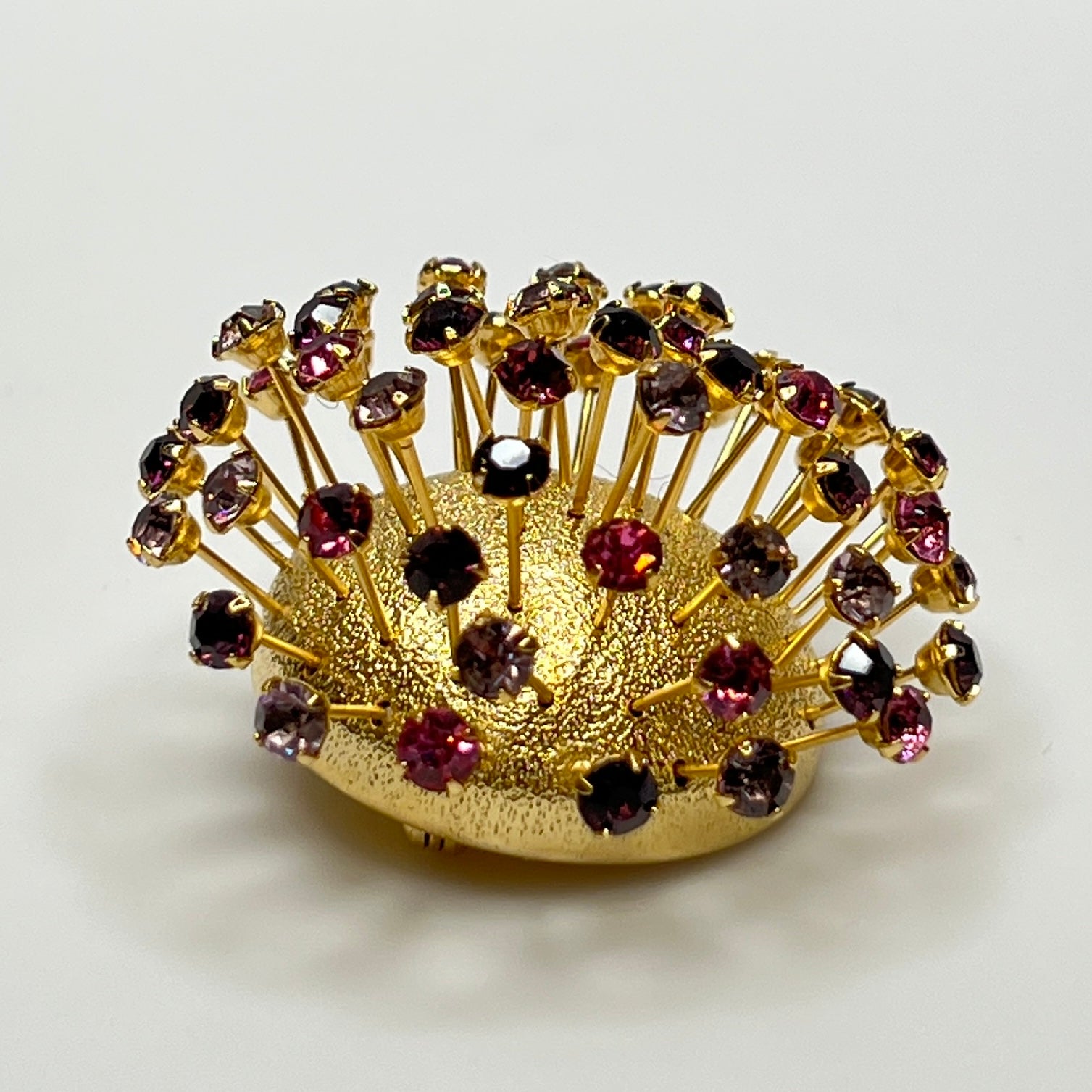 Corocraft goldtone Sputnik brooch with pink and purple rhinestones, mid-century style