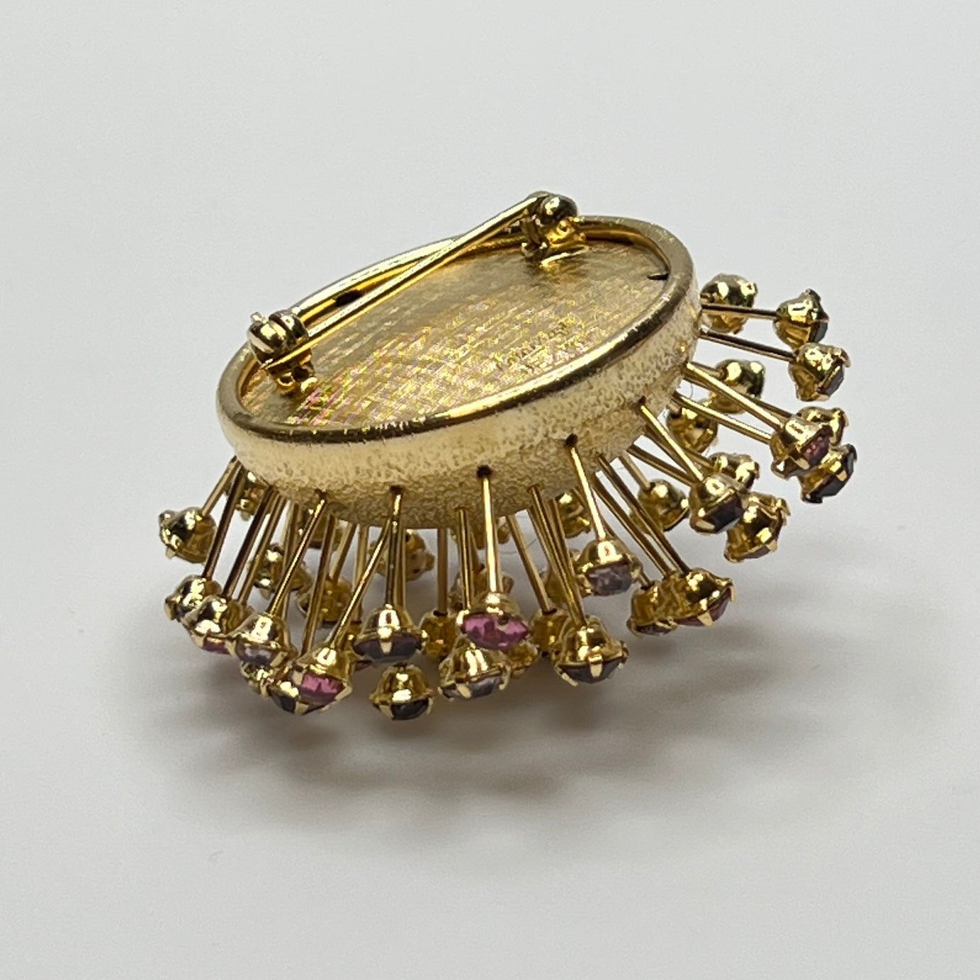Corocraft goldtone Sputnik brooch with pink and purple rhinestones, mid-century style