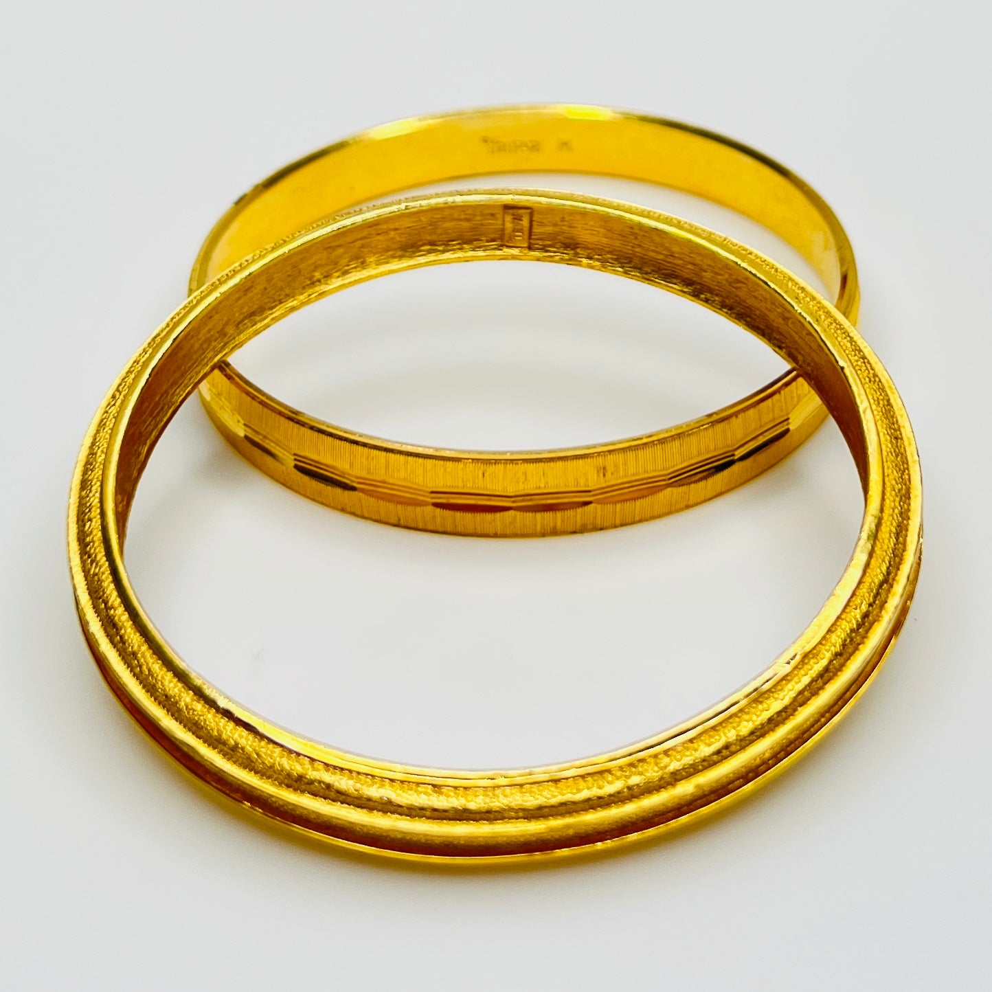 Signed Crown Trifari textured gold bangles interior stamp