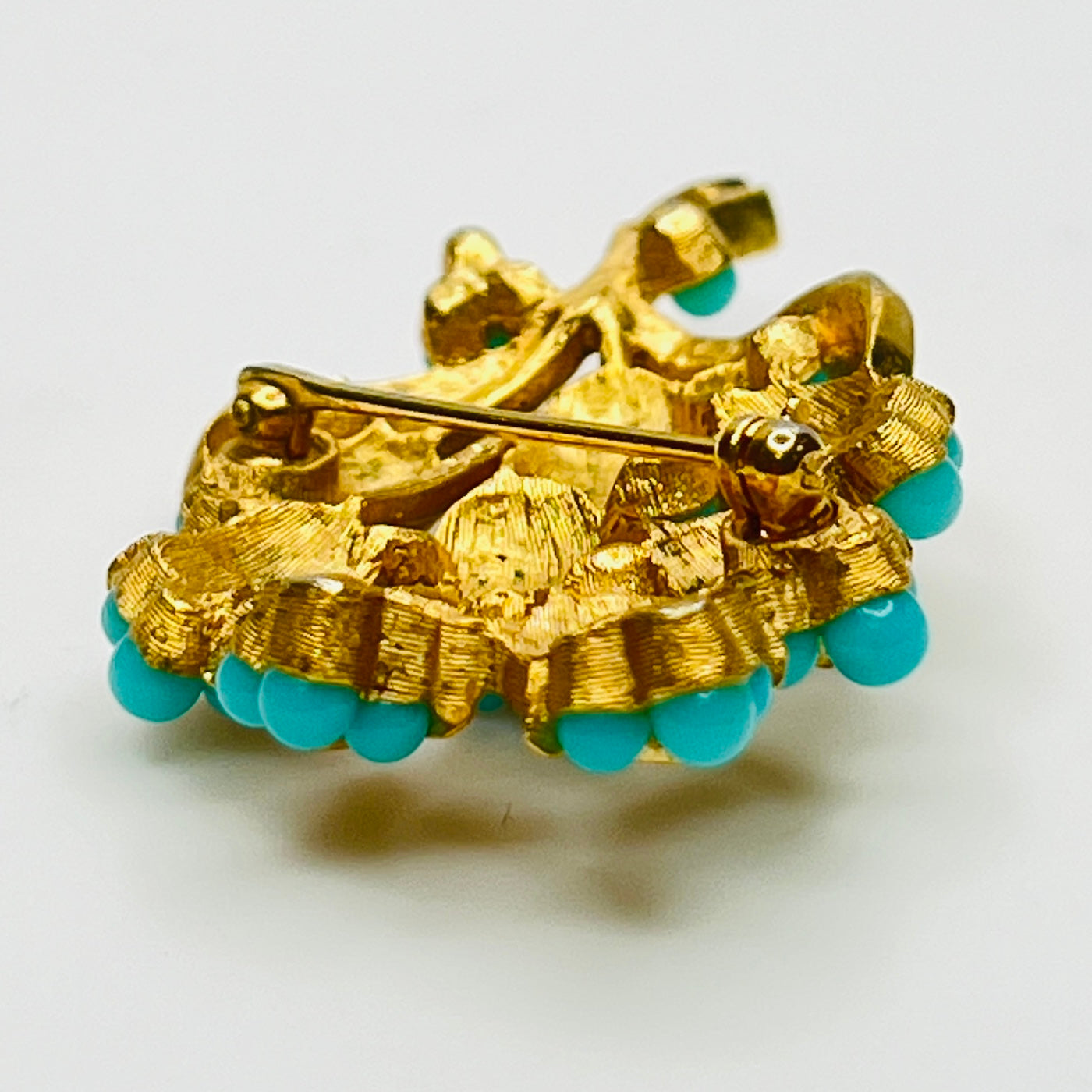 Gold tone floral brooch with faux turquoise beads