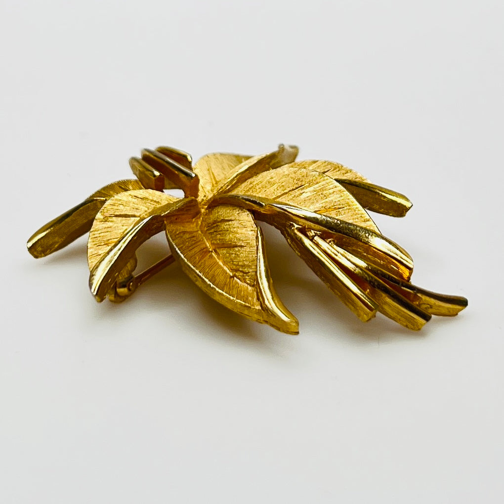 Crown Trifari brushed gold-tone leaf brooch with curling ribbon detail