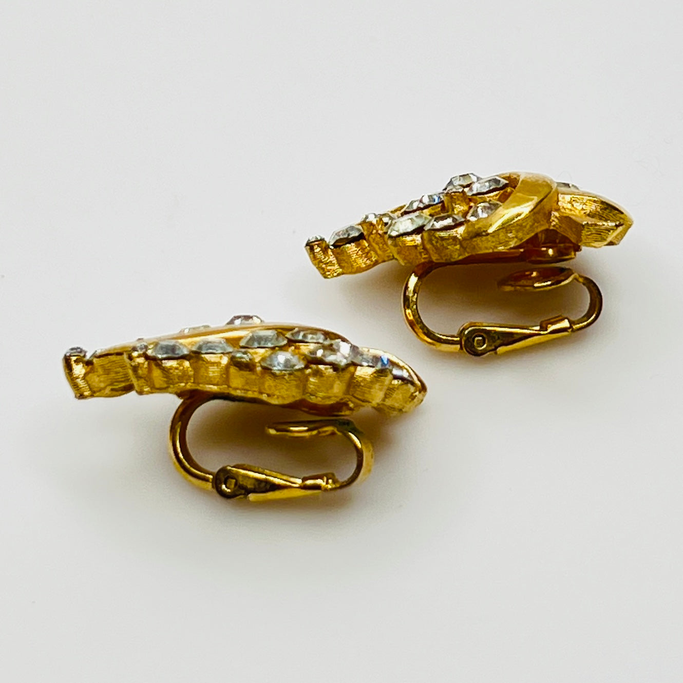 Pair of Crown Trifari rhinestone clip-on earrings with gold-tone finish