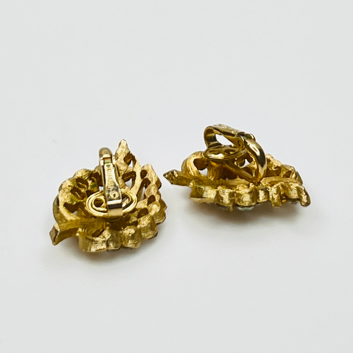 Pair of Crown Trifari rhinestone clip-on earrings with gold-tone finish