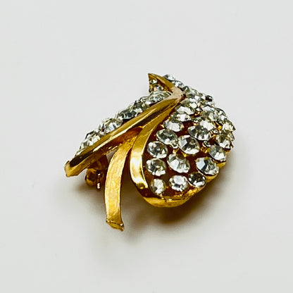 Close-up of Trifari brooch with clear rhinestones in leaf motif