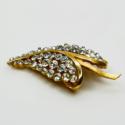 Close-up of Trifari brooch with clear rhinestones in leaf motif