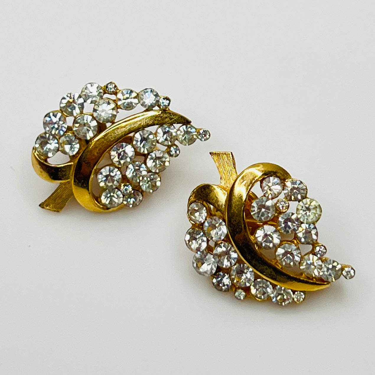 Pair of Crown Trifari rhinestone clip-on earrings with gold-tone finish