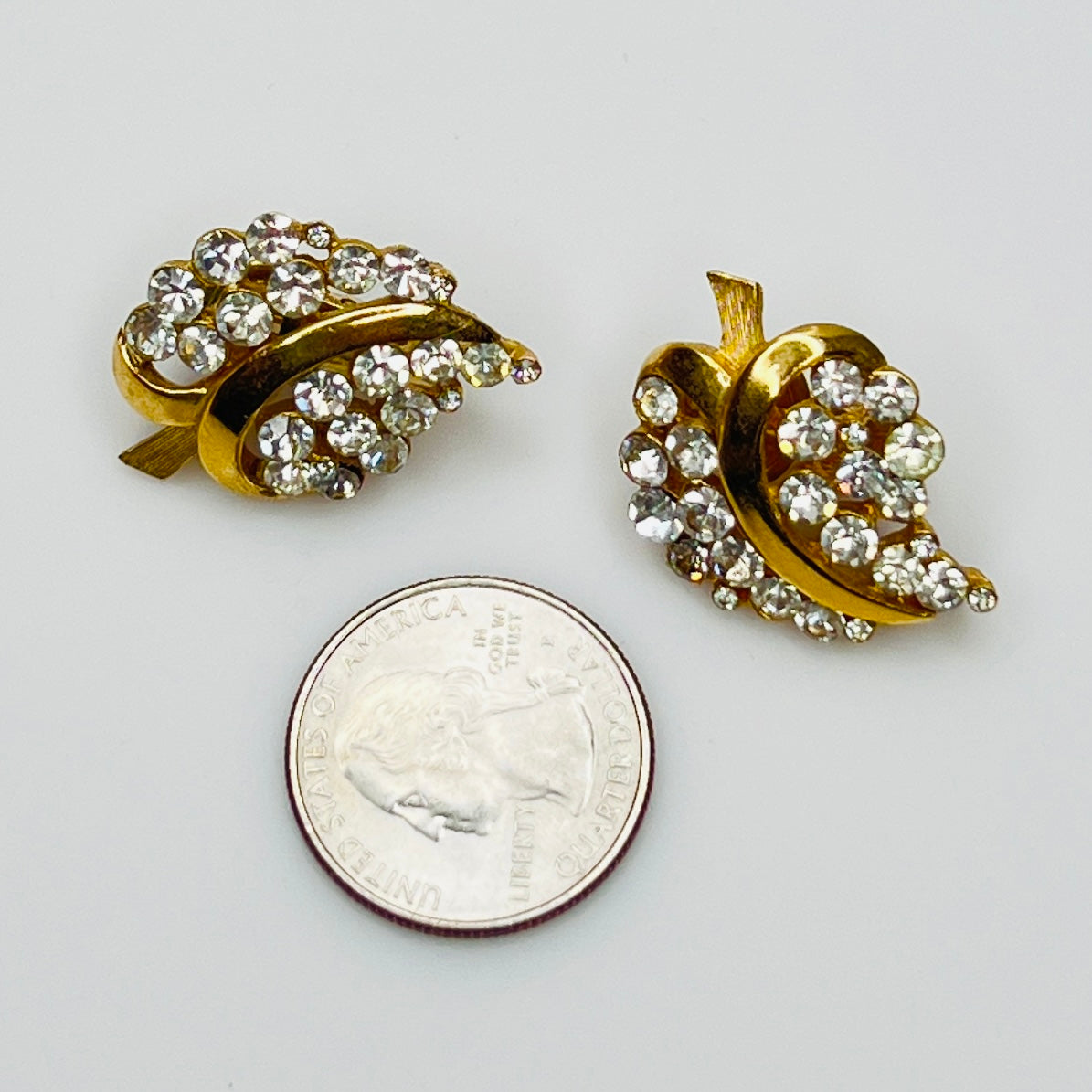 Pair of Crown Trifari rhinestone clip-on earrings with gold-tone finish