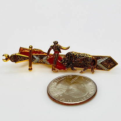 Matador tie clip next to quarter for size comparison